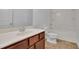 A neutral bathroom includes a shower-tub combo, a single vanity, and a toilet at 21 Belmore Manor Dr, Suwanee, GA 30024