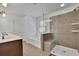 Modern bathroom featuring a glass shower, soaking tub, and double vanity with ample counter space, creating a spa-like retreat at 21 Belmore Manor Dr, Suwanee, GA 30024