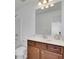 Traditional bathroom with a large mirror, vanity with drawers and cabinets, and a shower-tub combination at 21 Belmore Manor Dr, Suwanee, GA 30024