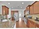 A modern eat-in kitchen offers stainless appliances, granite counters, and rich wood cabinets at 21 Belmore Manor Dr, Suwanee, GA 30024