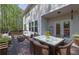 A lovely outdoor patio features an outdoor dining set, a wicker couch, and a wooden deck at 21 Belmore Manor Dr, Suwanee, GA 30024