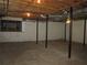 Unfinished basement with support beams and concrete floor at 2107 Briarwood Ct, Snellville, GA 30078