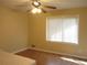Bright, light-filled bedroom with hardwood floors, large window, and ceiling fan at 2107 Briarwood Ct, Snellville, GA 30078