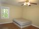 This bedroom has a ceiling fan and a window at 2107 Briarwood Ct, Snellville, GA 30078