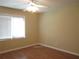 This bedroom features a ceiling fan and a window with blinds at 2107 Briarwood Ct, Snellville, GA 30078