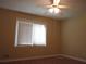 Bright bedroom with ceiling fan and window at 2107 Briarwood Ct, Snellville, GA 30078