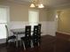 Dining room with hardwood floors, modern table, and natural light from two windows at 2107 Briarwood Ct, Snellville, GA 30078