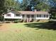 Charming single-Gathering home with well-maintained front lawn, mature trees, and inviting facade at 2107 Briarwood Ct, Snellville, GA 30078