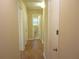 Hallway with wood floor and neutral paint, with an open doorway at the end at 2107 Briarwood Ct, Snellville, GA 30078
