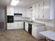 Bright kitchen featuring ample white cabinetry, tiled floor, and modern appliances at 2107 Briarwood Ct, Snellville, GA 30078
