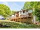 Home's backyard featuring a spacious deck made of wood, and luscious green grass on a sunny day at 2295 Piedmont Ridge Ct, Marietta, GA 30062