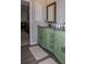 Bathroom with a light green vanity with a brown countertop and hardwood flooring at 2295 Piedmont Ridge Ct, Marietta, GA 30062