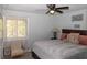 Bedroom with a bed, chair, window with light filtering curtains, and wall decor at 2295 Piedmont Ridge Ct, Marietta, GA 30062