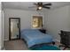 Bedroom featuring plush carpet, a ceiling fan, and a mirror reflecting natural light from the window at 2295 Piedmont Ridge Ct, Marietta, GA 30062