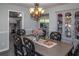 A formal dining room with grey walls, a dining table with chairs, and a decorative cabinet at 2295 Piedmont Ridge Ct, Marietta, GA 30062