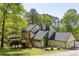 Modern home with a black roof, wooden stairs, well-manicured lawn, and attached two car garage at 2295 Piedmont Ridge Ct, Marietta, GA 30062