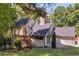 Stylish home with a black roof, wooden stairs, and a spacious front yard with ample green space at 2295 Piedmont Ridge Ct, Marietta, GA 30062