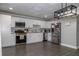 A modern kitchen featuring grey floors, white cabinets, stainless steel appliances, and modern lighting at 2295 Piedmont Ridge Ct, Marietta, GA 30062