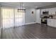 A modern kitchen featuring grey floors, white cabinets, stainless steel appliances, and a sliding glass door at 2295 Piedmont Ridge Ct, Marietta, GA 30062