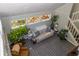 Bright living room featuring a sofa, armchairs, indoor plants, and an array of windows at 2295 Piedmont Ridge Ct, Marietta, GA 30062