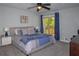 Comfortable carpeted main bedroom with ceiling fan and sliding glass doors to a deck at 2295 Piedmont Ridge Ct, Marietta, GA 30062