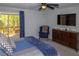Inviting main bedroom with a walkout balcony, ceiling fan, and large TV at 2295 Piedmont Ridge Ct, Marietta, GA 30062