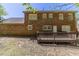 Back of a brick house with multiple windows, a wood deck, and a yard at 6330 Phillips Pl, Lithonia, GA 30058
