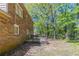 The back of a brick house features a wood deck and a wooded backyard at 6330 Phillips Pl, Lithonia, GA 30058