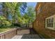 Wood deck overlooks the wooded backyard behind the brick house at 6330 Phillips Pl, Lithonia, GA 30058