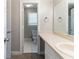 A well-lit bathroom features tile flooring, a toilet, and a sink with a large mirror at 6330 Phillips Pl, Lithonia, GA 30058
