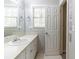 Bathroom with sink, vanity, mirror, window and vinyl tile flooring at 6330 Phillips Pl, Lithonia, GA 30058