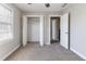 Bedroom with neutral paint, carpet, standard closet, window, and doors at 6330 Phillips Pl, Lithonia, GA 30058