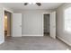 A spacious carpeted bedroom offers two closets, white trim, and neutral walls at 6330 Phillips Pl, Lithonia, GA 30058