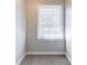 Bright bedroom features a window with blinds and neutral carpeting at 6330 Phillips Pl, Lithonia, GA 30058