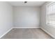 This bedroom has neutral colored carpet and paint with a window and ceiling fan at 6330 Phillips Pl, Lithonia, GA 30058
