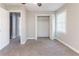 Bedroom featuring neutral carpet and paint, two closets, and a window at 6330 Phillips Pl, Lithonia, GA 30058