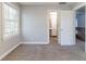 Bedroom with neutral carpet and paint leads to bathroom and stairs at 6330 Phillips Pl, Lithonia, GA 30058