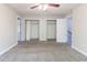 Spacious bedroom showcases two closets, neutral colors and a ceiling fan at 6330 Phillips Pl, Lithonia, GA 30058