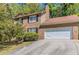 Charming brick two-story home with an attached two-car garage and a driveway at 6330 Phillips Pl, Lithonia, GA 30058