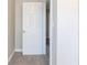 Hallway view features neutral carpeting, white trim, and white painted doors at 6330 Phillips Pl, Lithonia, GA 30058