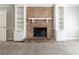Living room features a brick fireplace with built-in shelving on both sides at 6330 Phillips Pl, Lithonia, GA 30058