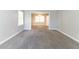 Spacious living room featuring neutral colors, carpet flooring, and ample natural light at 6330 Phillips Pl, Lithonia, GA 30058