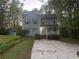 Charming two-story home with a welcoming front porch, neat landscaping, and a spacious front yard at 691 Aberdeen Dr, Stone Mountain, GA 30083