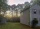 Side view of a two-story home with vinyl siding and a large, tree-filled backyard at 691 Aberdeen Dr, Stone Mountain, GA 30083