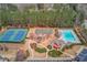 A stunning aerial view of the community pool, clubhouse, tennis courts, and playground, perfect for an active lifestyle at 1005 Anise Ct, Dacula, GA 30019