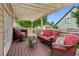 Relaxing back deck with comfortable seating, pergola, and wooded views at 1005 Anise Ct, Dacula, GA 30019