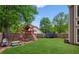 Spacious backyard featuring a playset, trampoline, and a well-maintained lawn at 1005 Anise Ct, Dacula, GA 30019