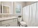 Bright bathroom with a granite countertop vanity and shower with tub at 1005 Anise Ct, Dacula, GA 30019