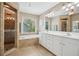 Elegant bathroom featuring a soaking tub, glass shower, and double sink vanity at 1005 Anise Ct, Dacula, GA 30019