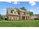 Beautiful two-story brick home with manicured lawn and lovely landscaping at 1005 Anise Ct, Dacula, GA 30019